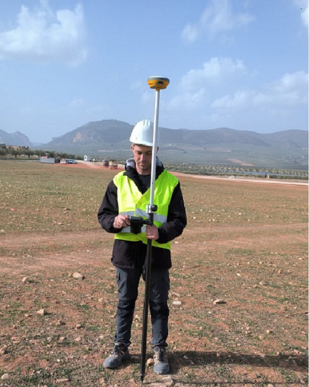 Surveyor with a GPS receiver setting out points on site