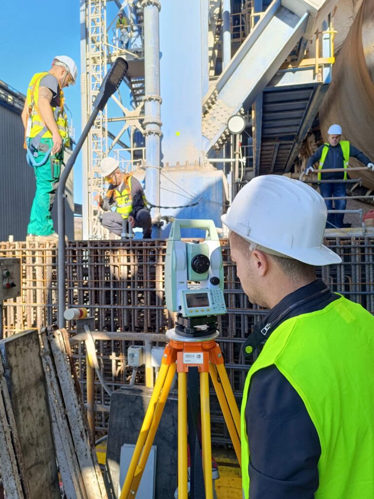 Surveyor with a total station setting out anchor groups at Devnya Cement